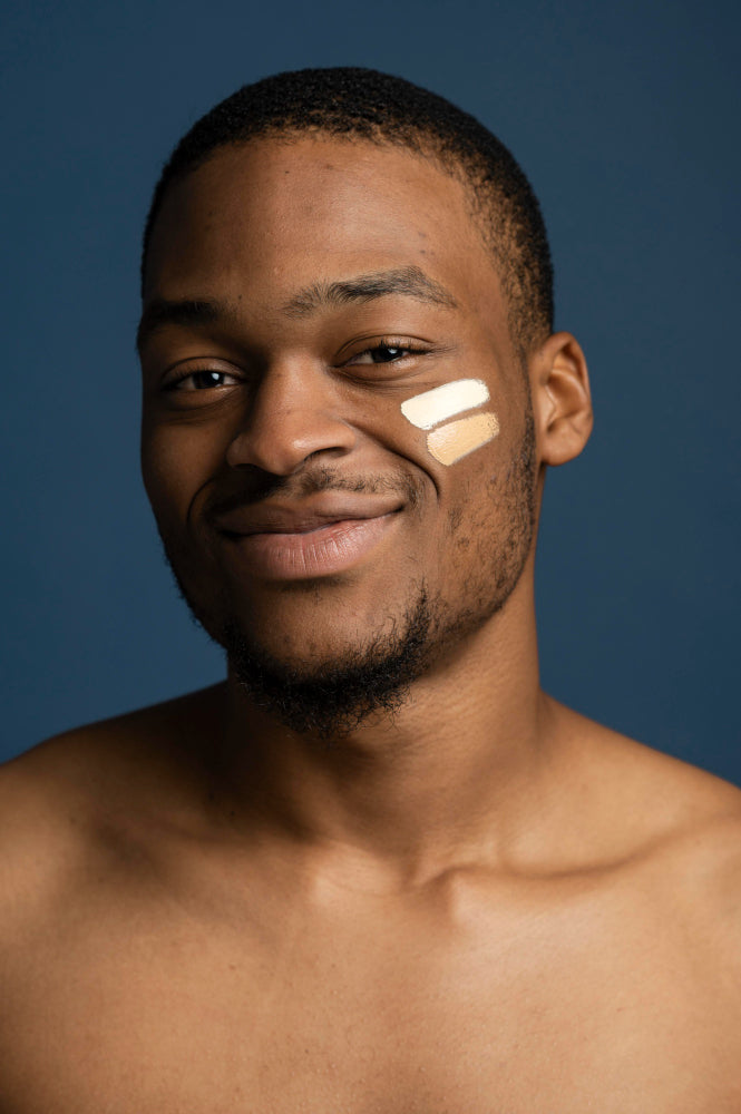 Sunscreen on smiling young black skin man