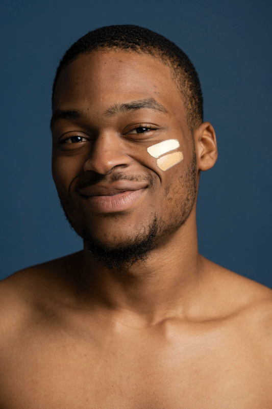 Sunscreen on smiling young black skin man