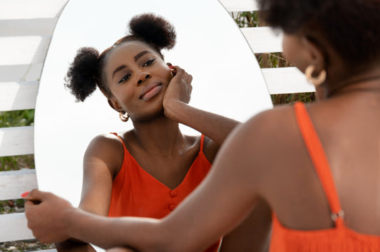 Oversebaceous Activity Unveiled: Young african lady facing mirror