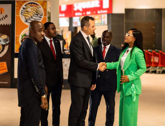 Dr. Edith Gibson sharing a handshake with H.E. Matt Wood the British high commisioner