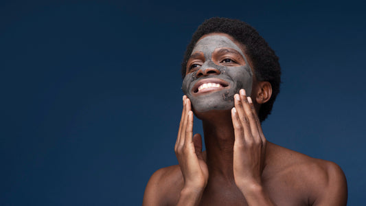 Melanin Skincare - portrait-man-smiling-with-charcoal-mask-his-face